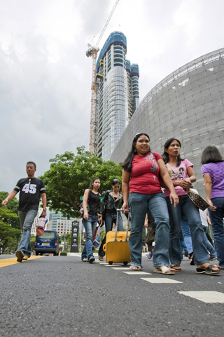 The building of the shopping mall ION Orchard over a picnic spot that was popular with the Filipino maid community for years has forced them to find new spaces in the vicinity to relax.
